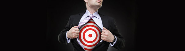 A man pulling open his dress shirt (Superman-Style) revealing a bullseye on his chest.