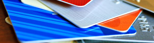 A stack of different colored credit cards.