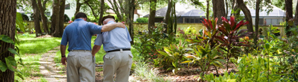 Photo: Man helping elderly walk