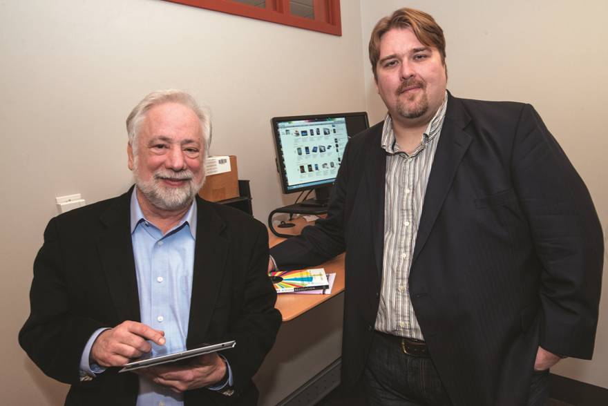 Photo of two men using iPad Photo of two men using iPad