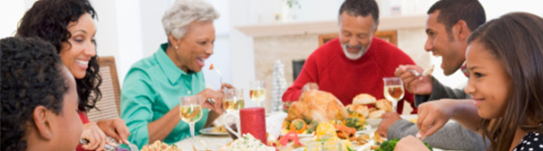 Photo of a family around the thanksgiving dinner table