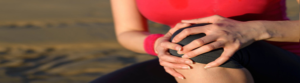 Woman holding hurt knee