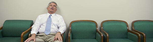 Bored man sleeping in chair