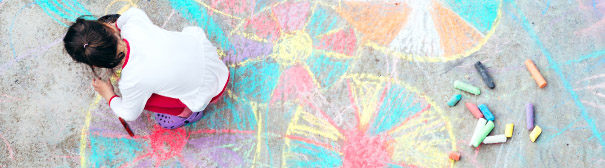 child drawing with chalk